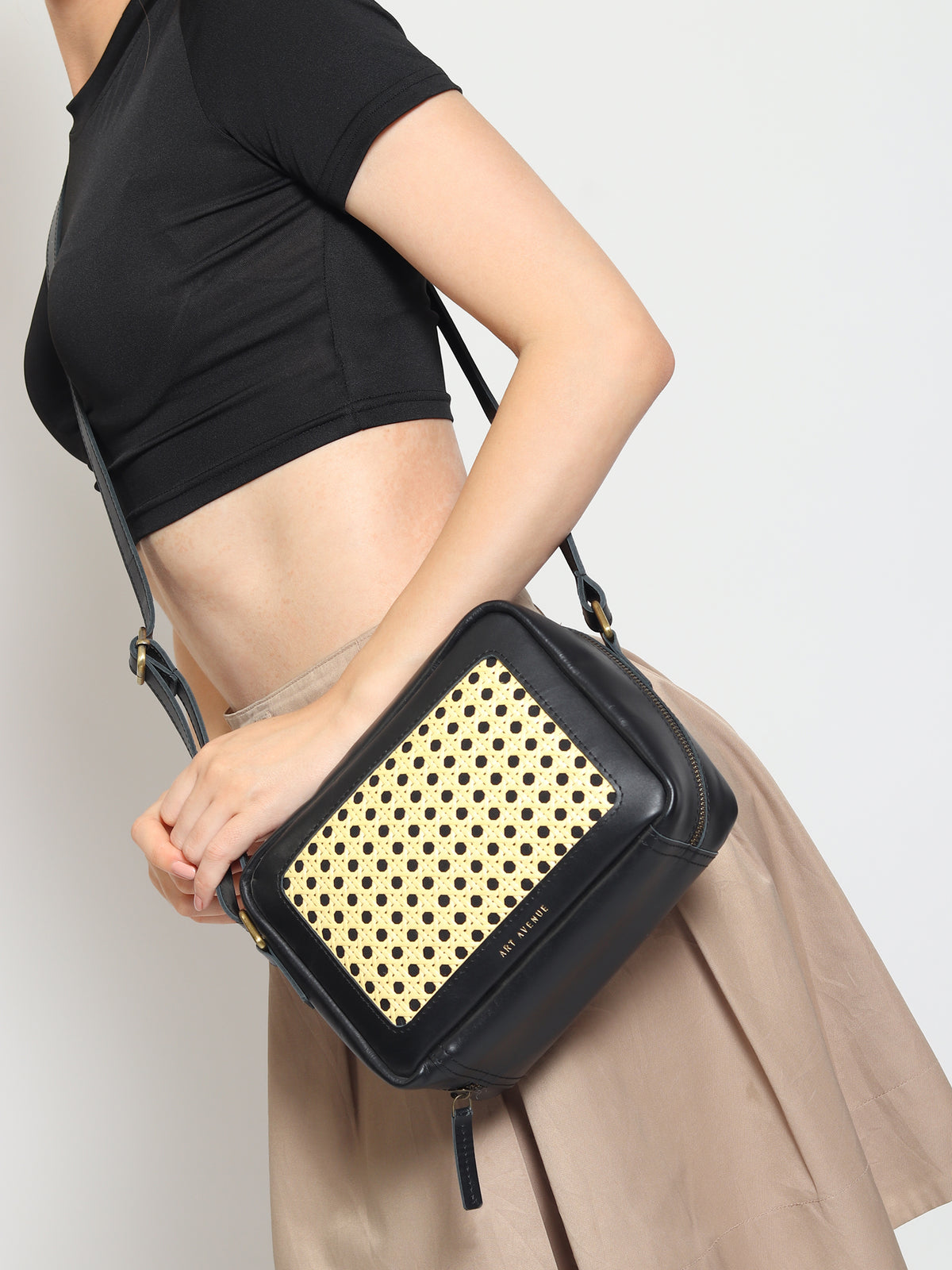 Laremy cane and leather sling bag flat lay — Art Avenue
