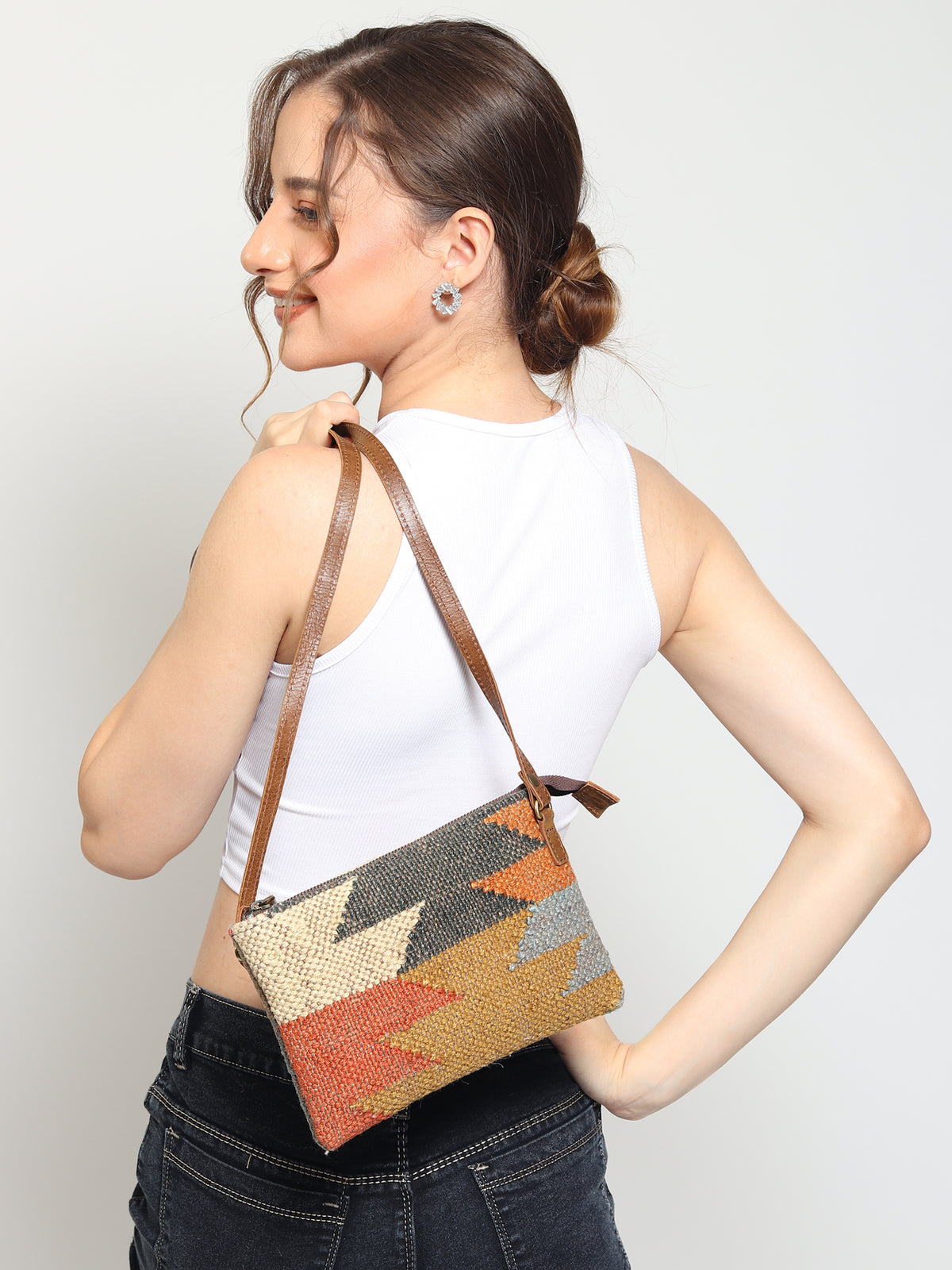 Lauris kilim and leather sling bag flat lay — Art Avenue