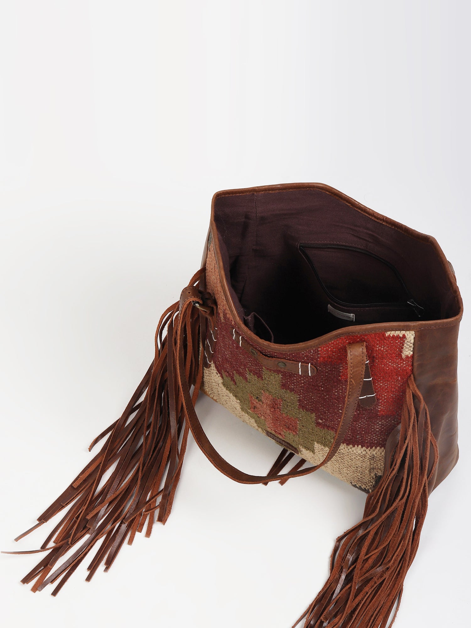 Bohemian kilim and leather handbag flat lay — Art Avenue