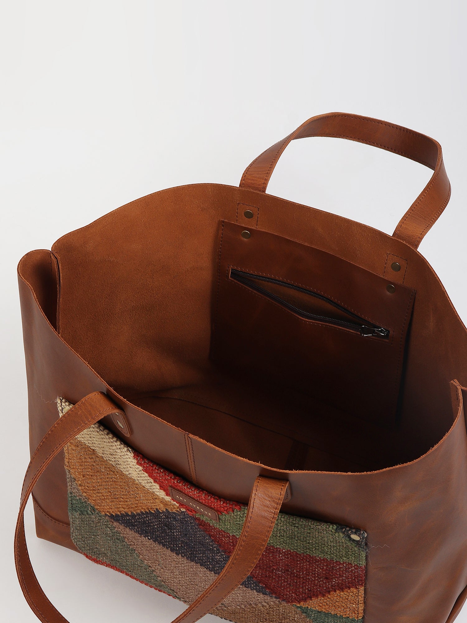 Sarah kilim and leather handbag flat lay — Art Avenue