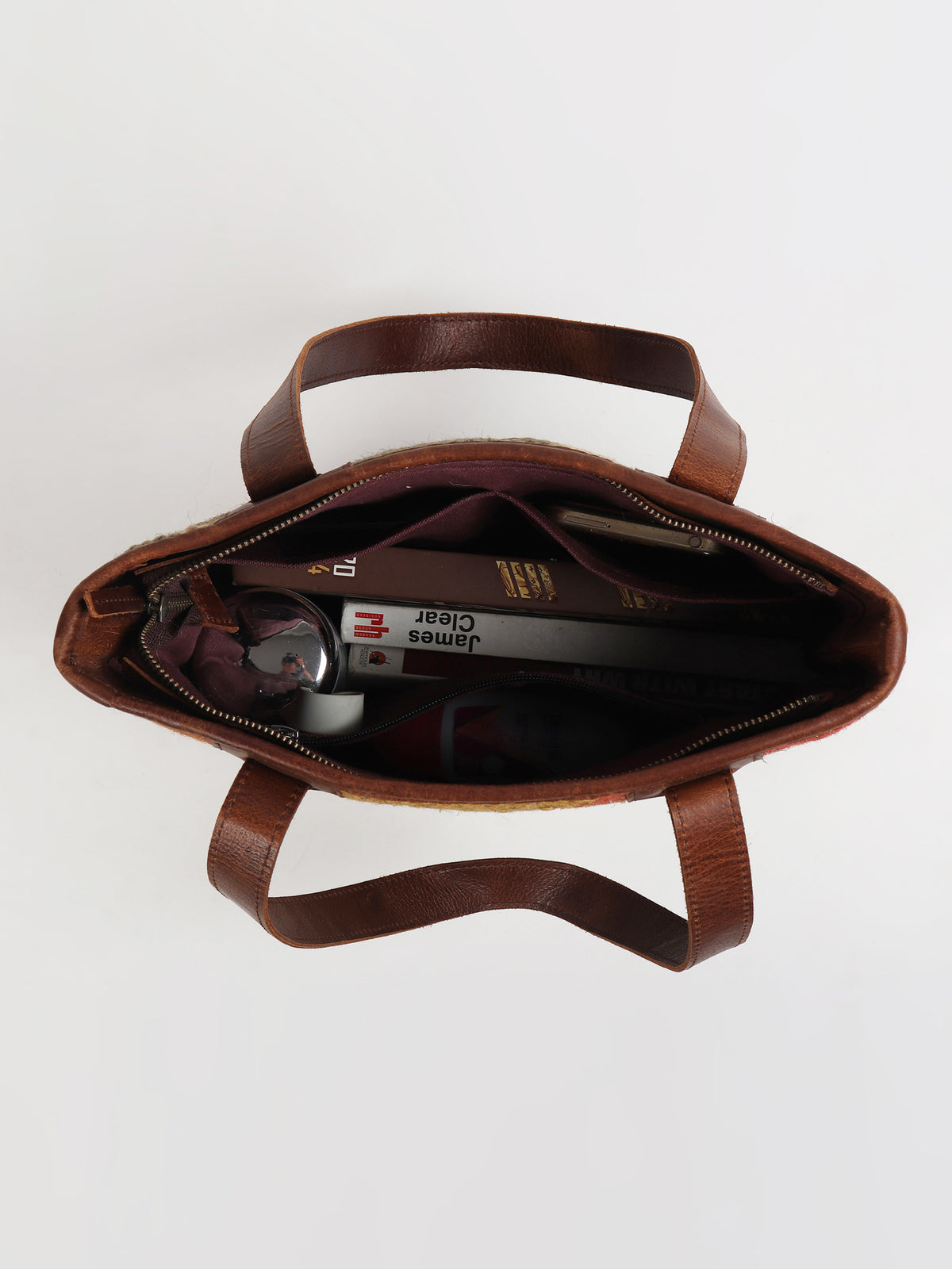 Camelia kilim and leather handbag flat lay — Art Avenue