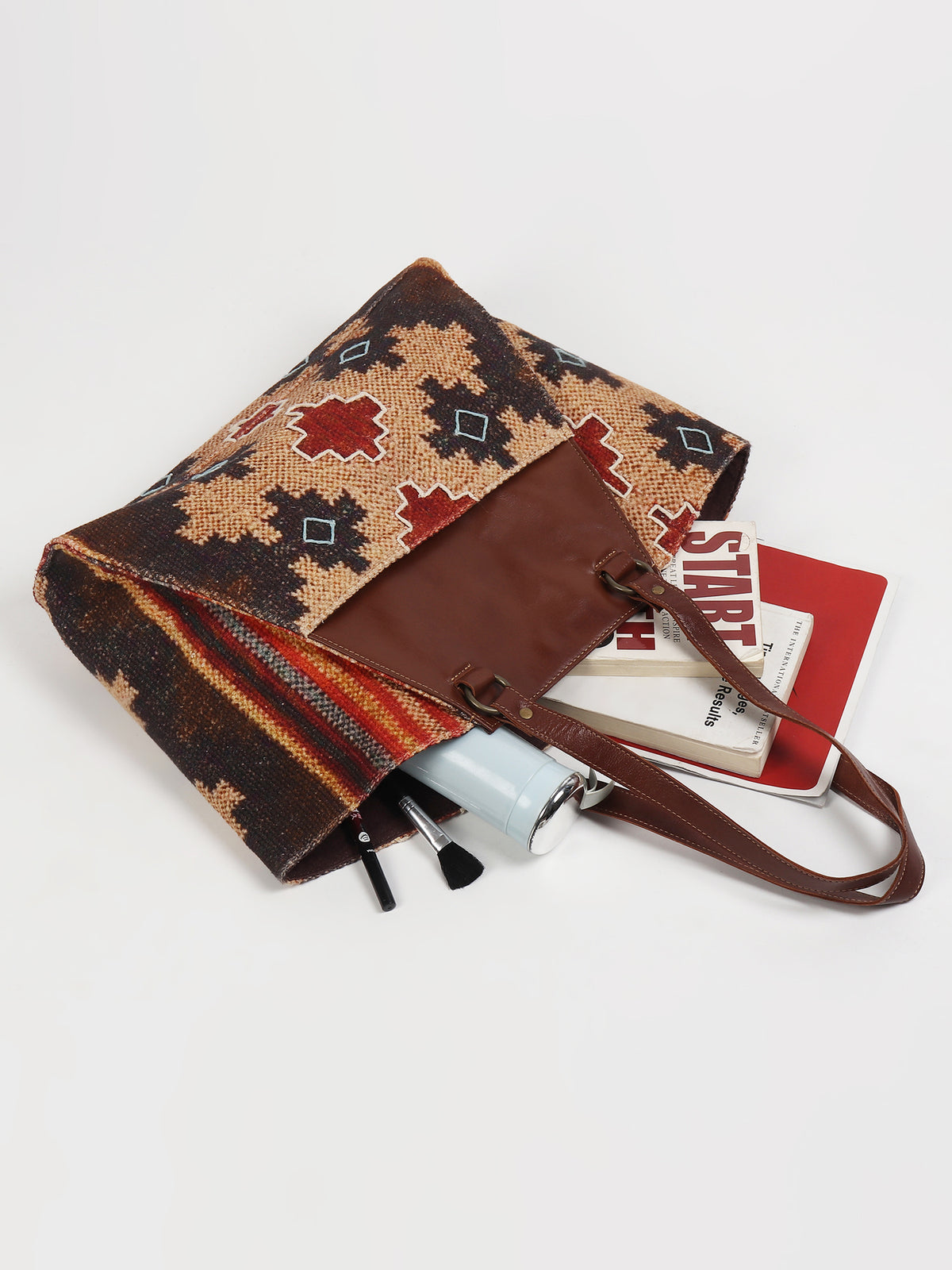Zemin printed kilim and leather handbag flat lay — Art Avenue