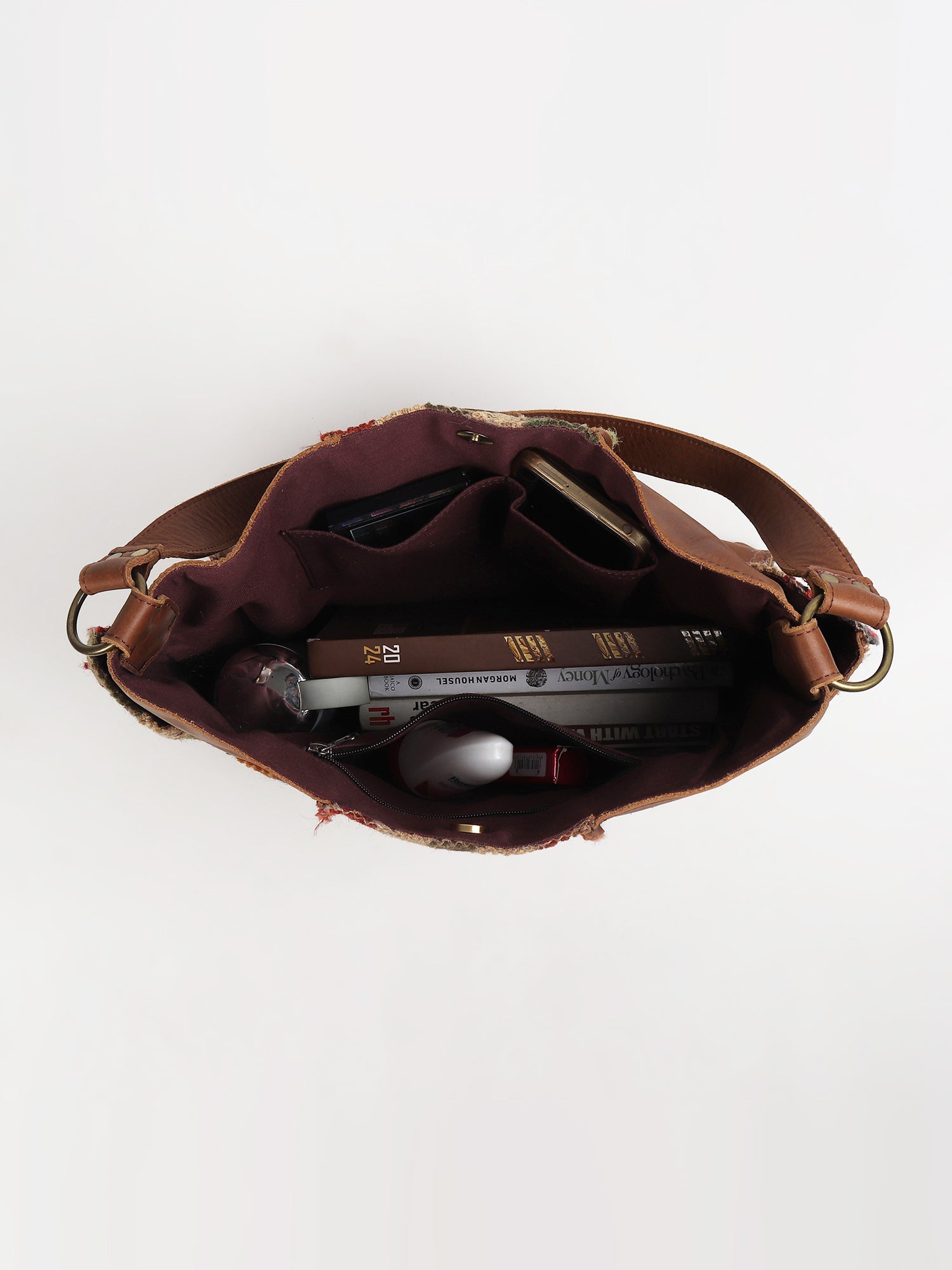 Behoove kilim and leather patchwork handbag flat lay — Art Avenue