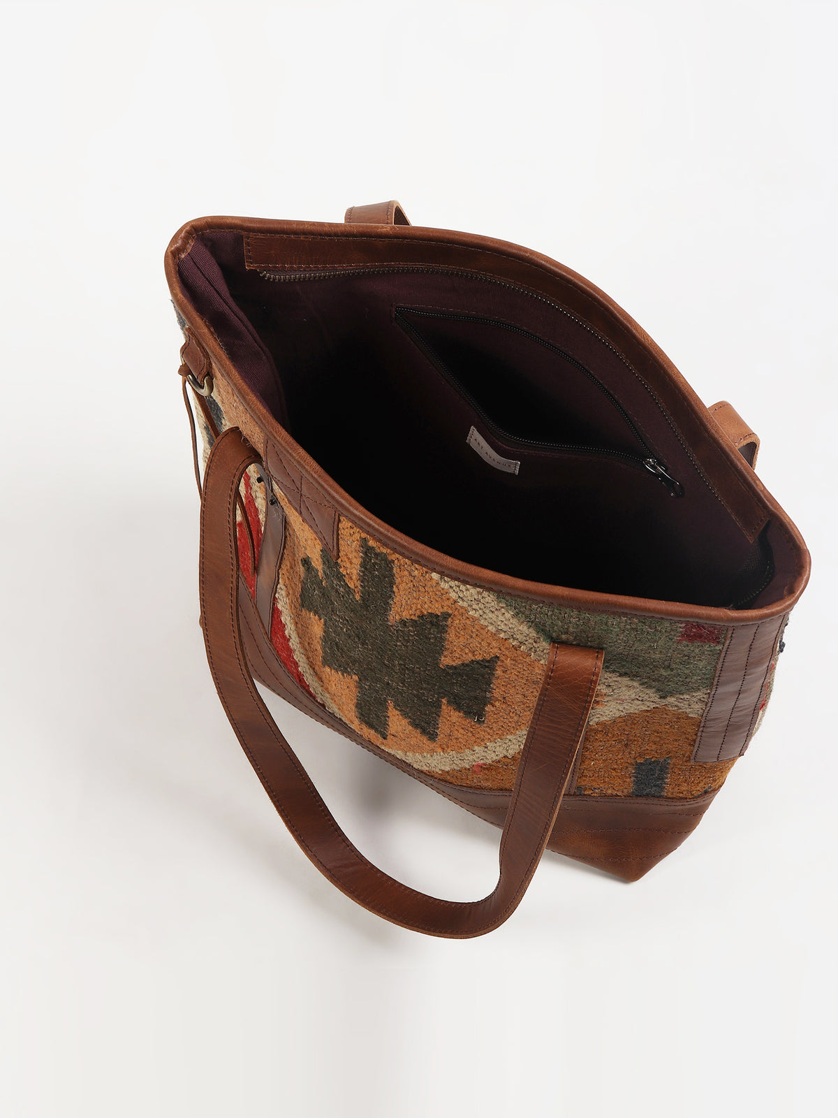 Aneur kilim and leather handbag flat lay — Art Avenue