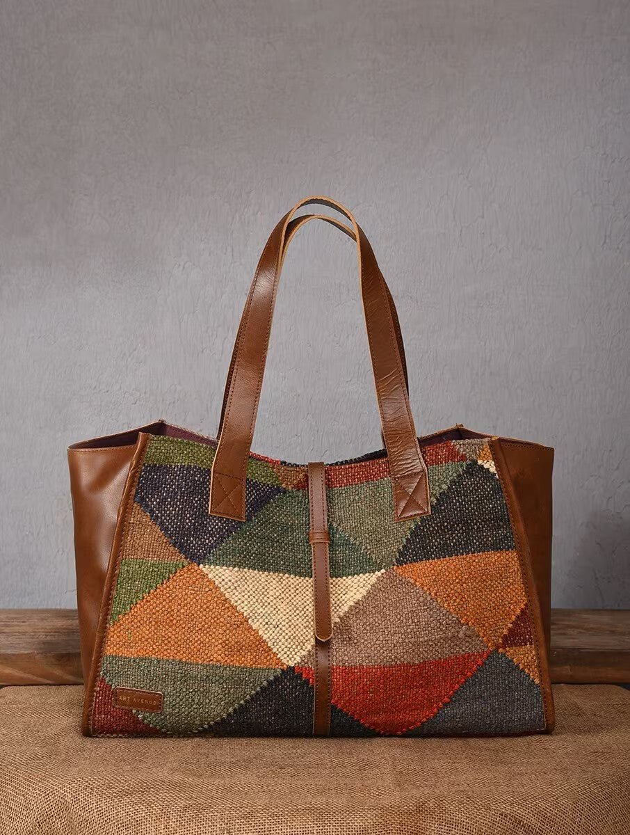 Umbra kilim and leather handbag flat lay — Art Avenue