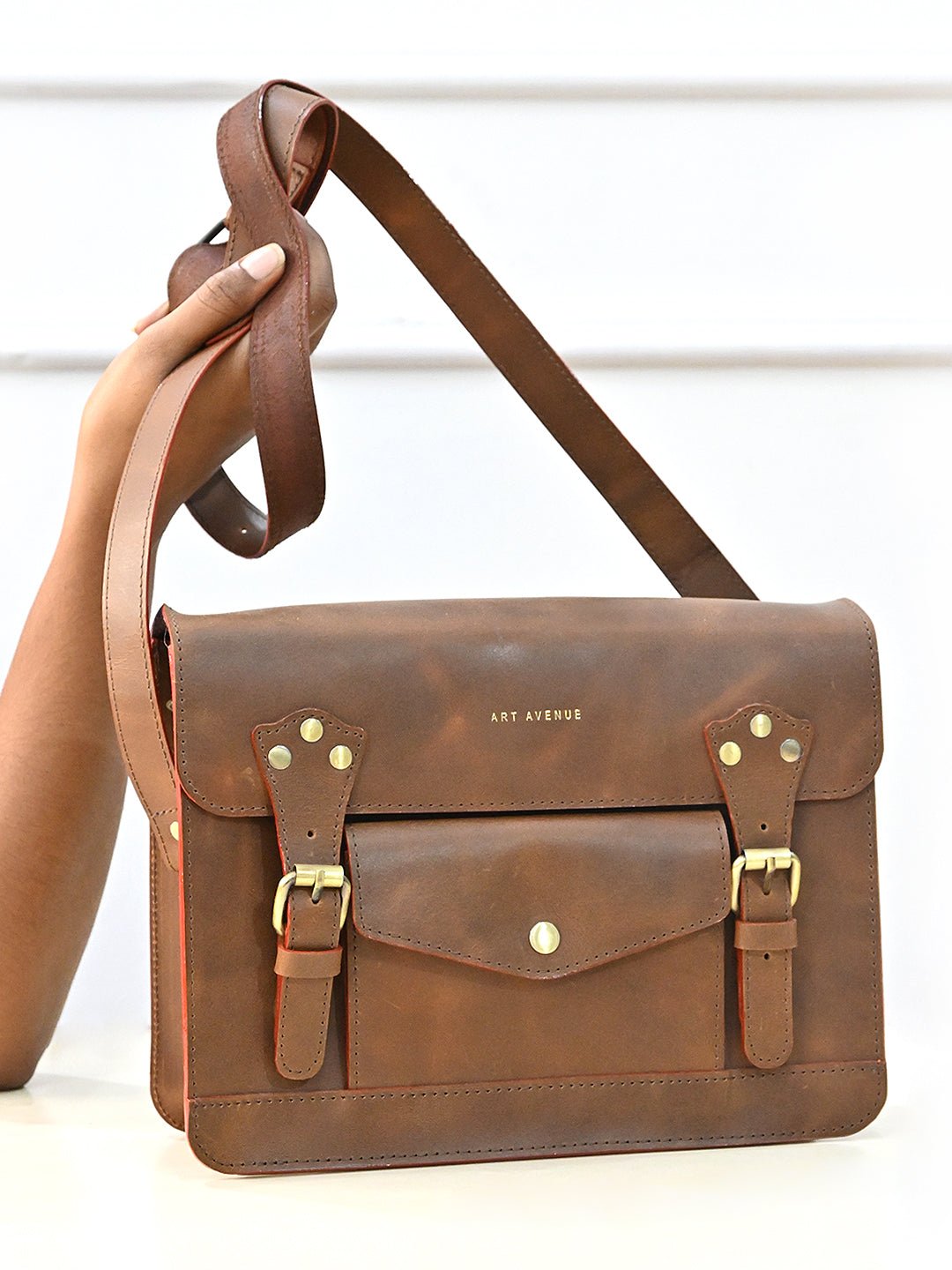 Obsidian leather sling bag on model — Art Avenue
