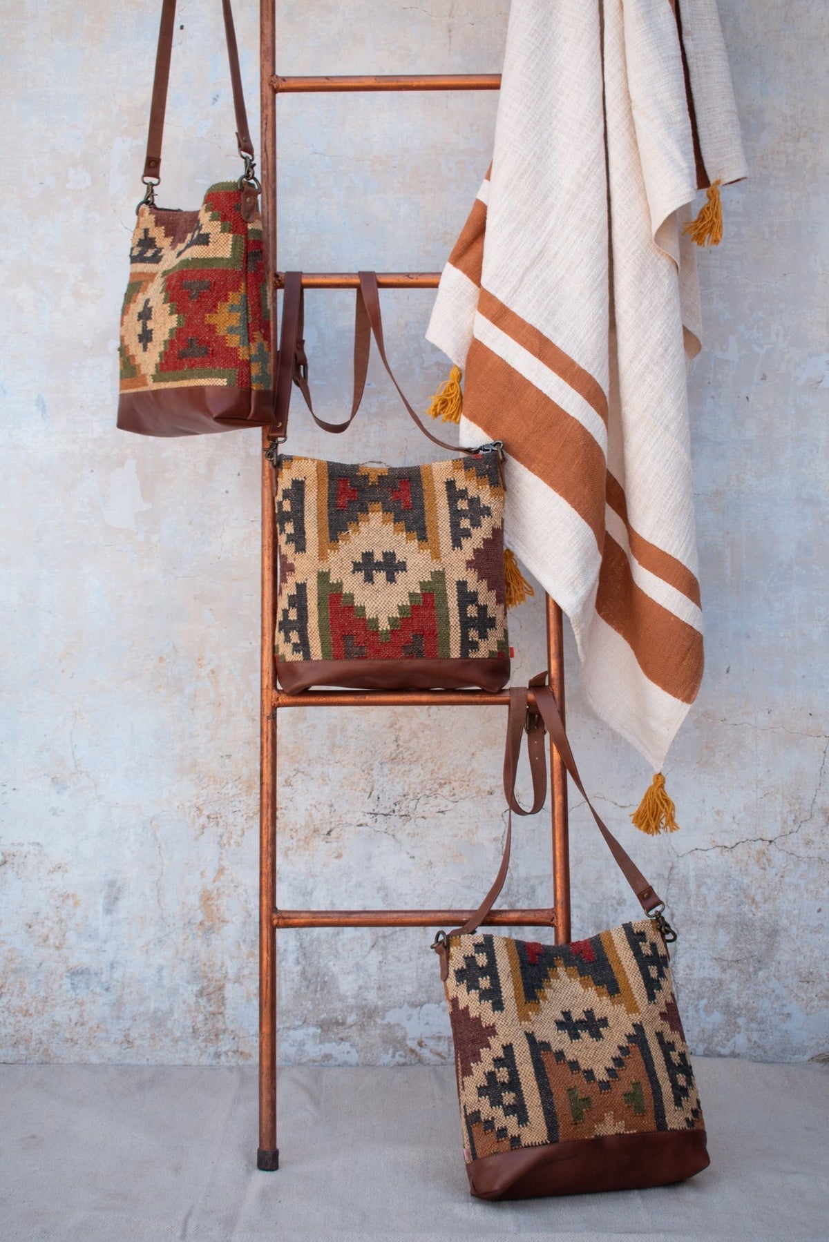 Austere kilim and leather handbag flat lay — Art Avenue