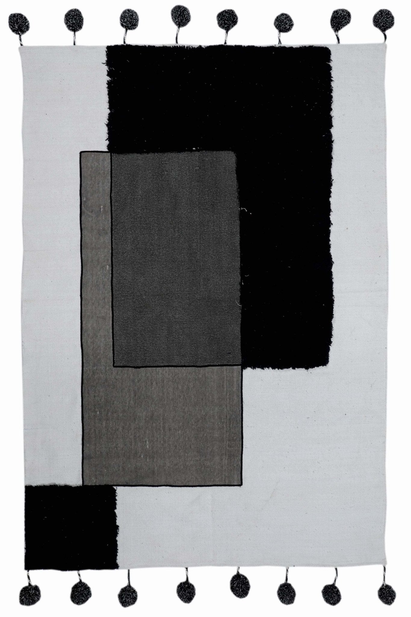 Kelki patchwork rug detail — pom-pom trim