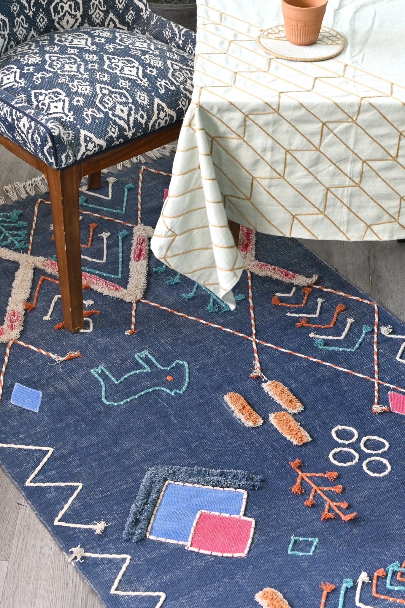 Nicobar embroidered rug room setting — Art Avenue India