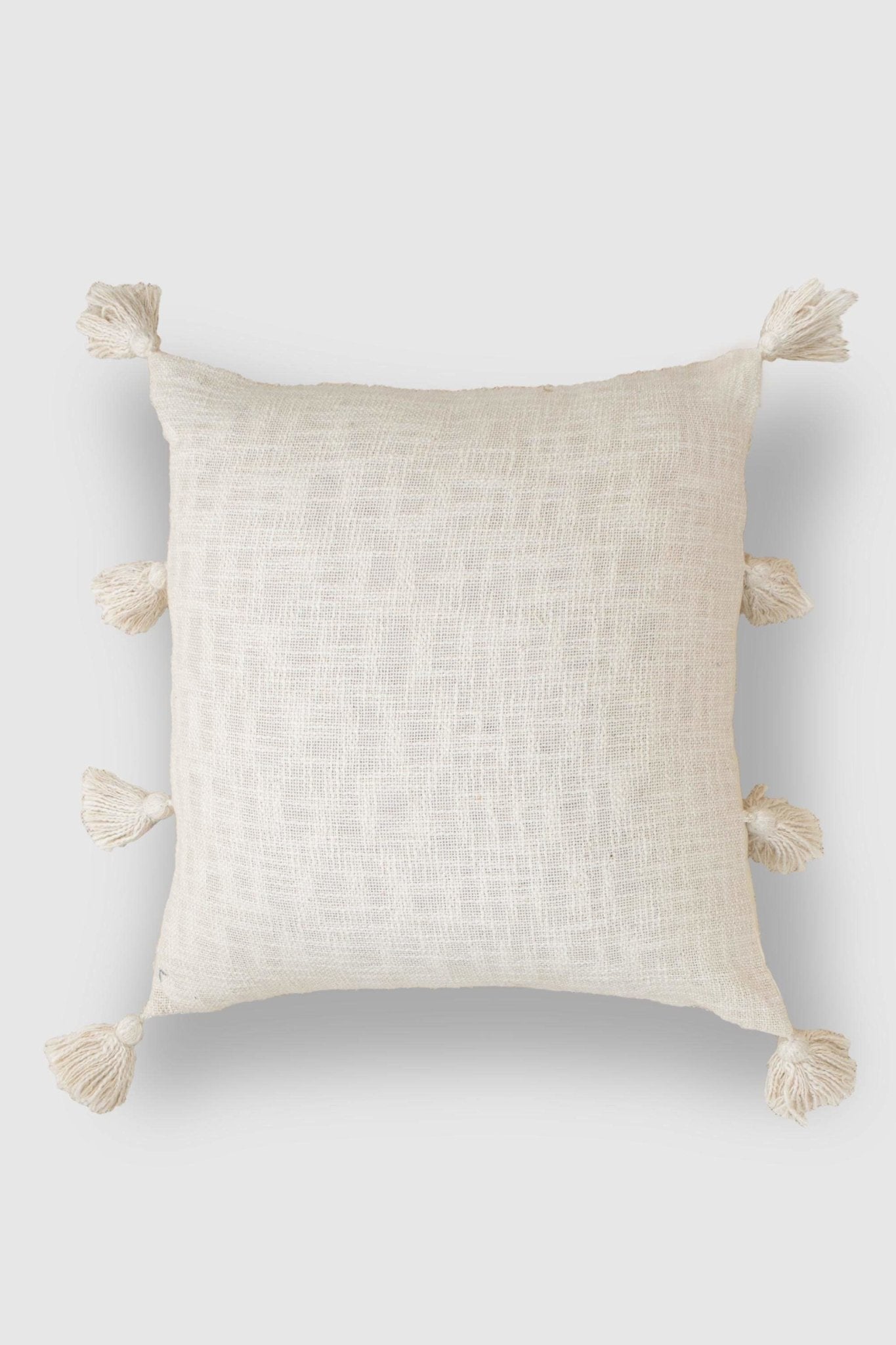 Hand-embroidered square cushion on sofa — Art Avenue