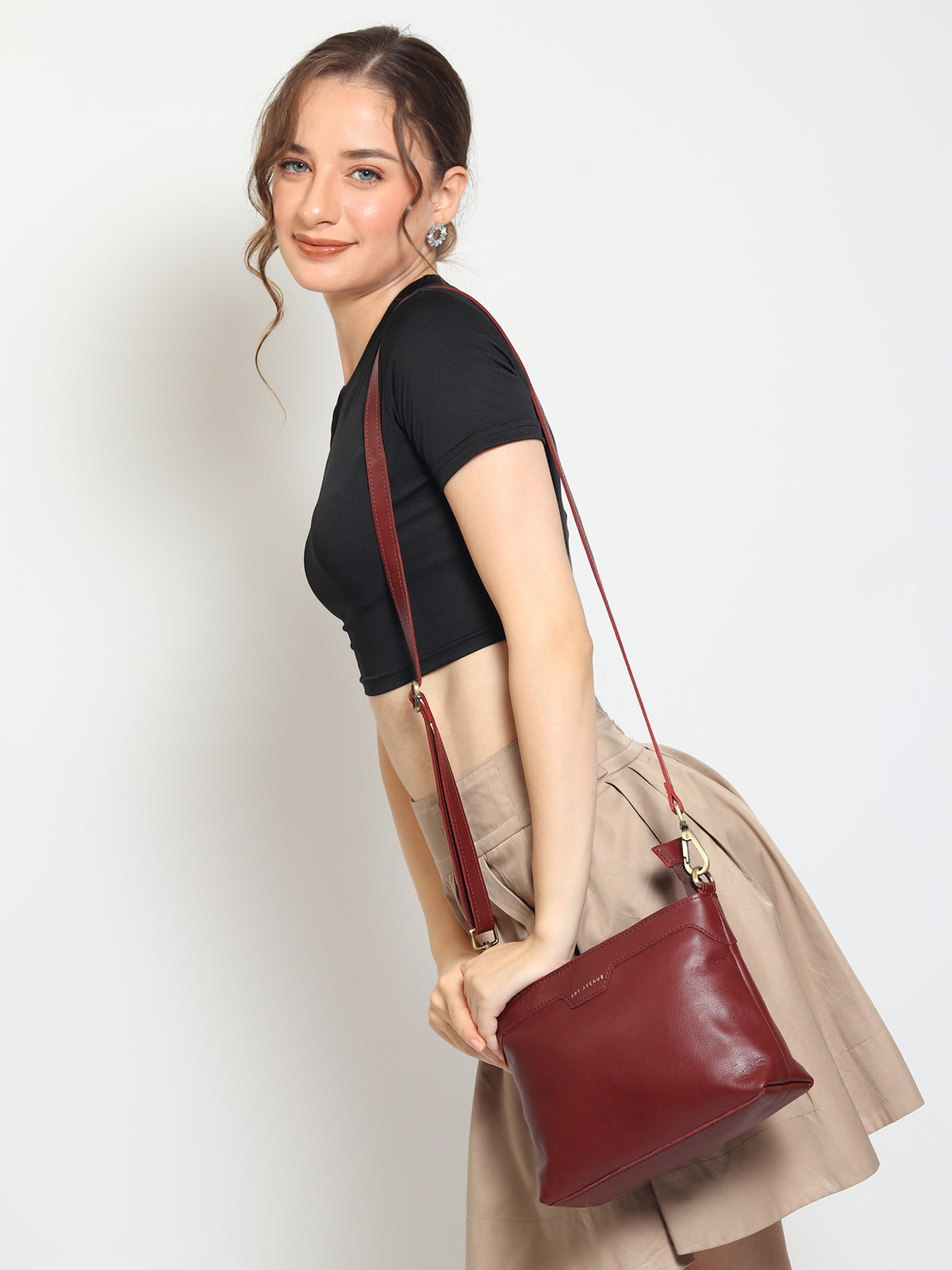Ladislao leather sling bag flat lay — Art Avenue