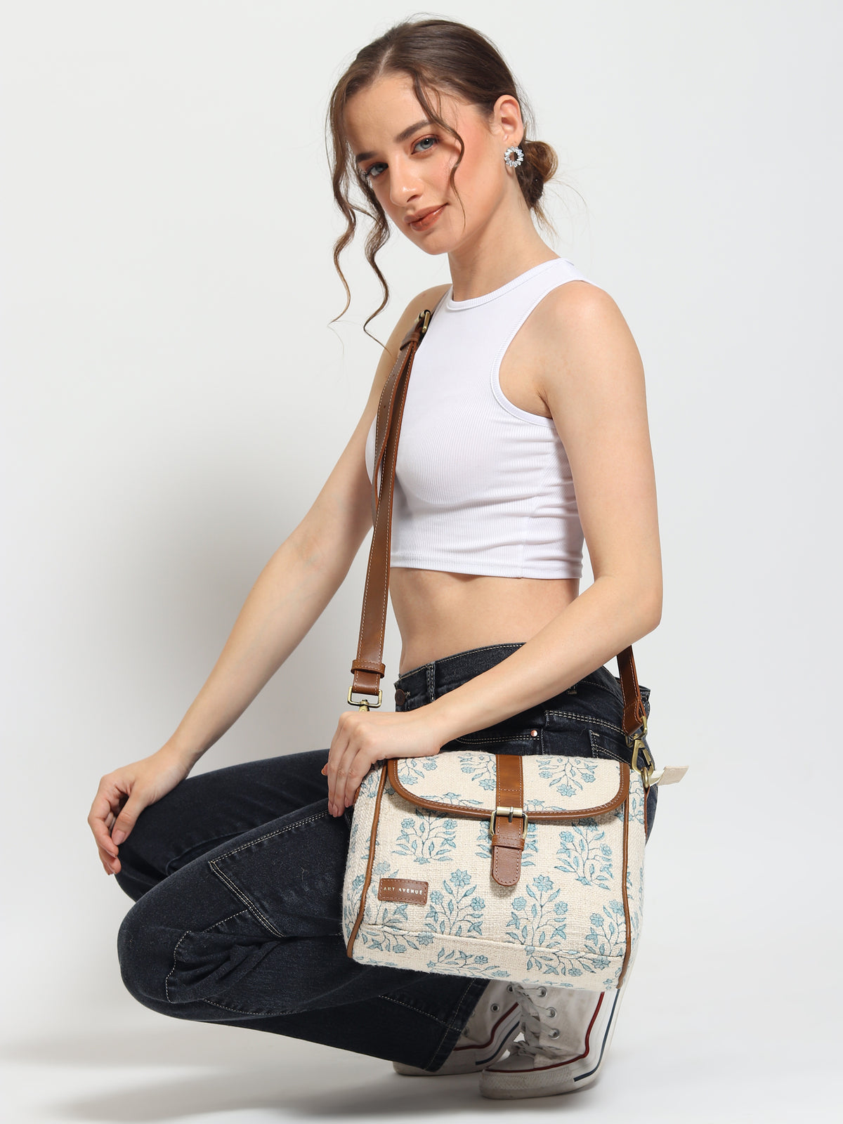 Carter block-printed and leather sling bag closure detail — Art Avenue