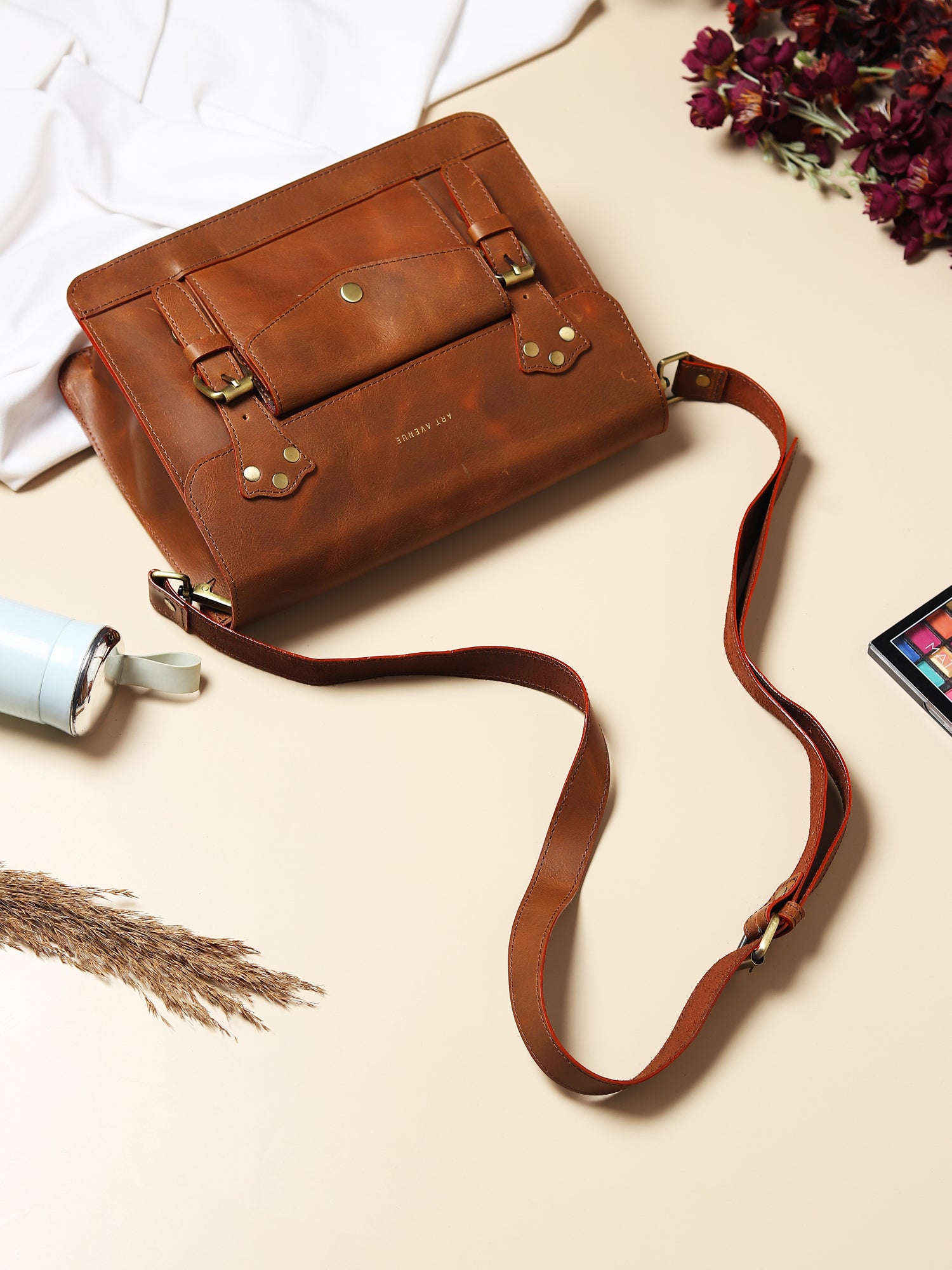 Obsidian leather sling bag front detail — Art Avenue