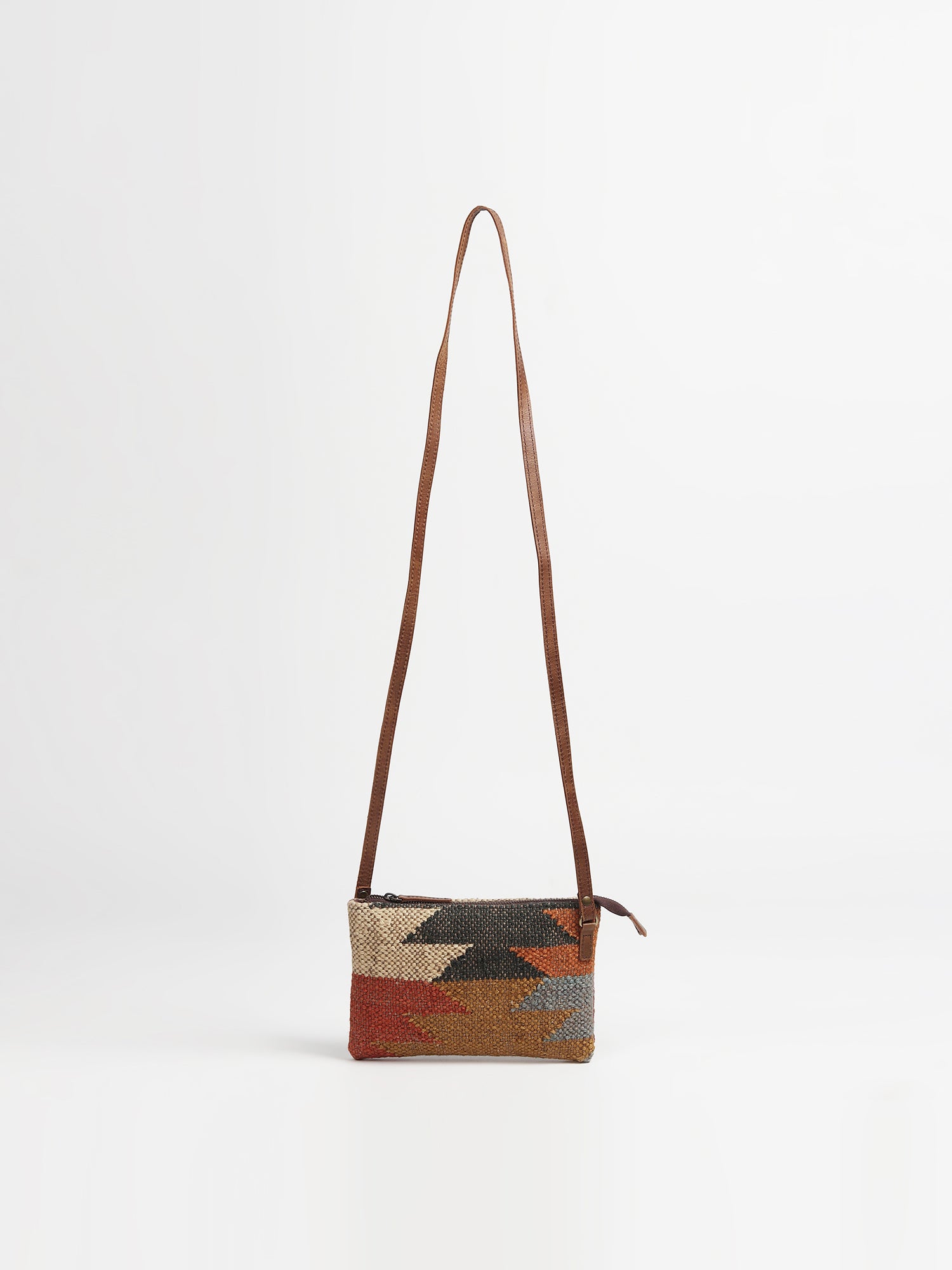 Lauris leather and kilim sling bag, side view — Art Avenue