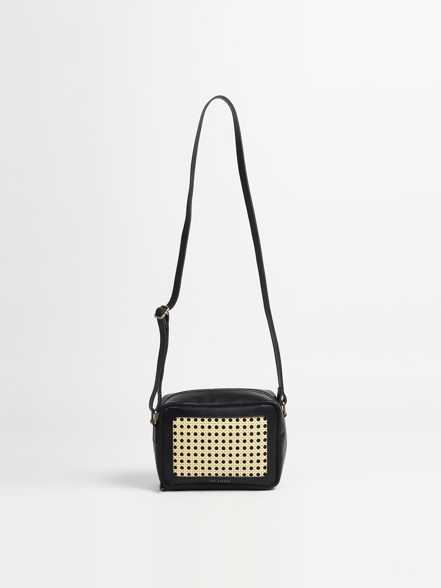 Laremy leather and cane sling bag, side view — Art Avenue