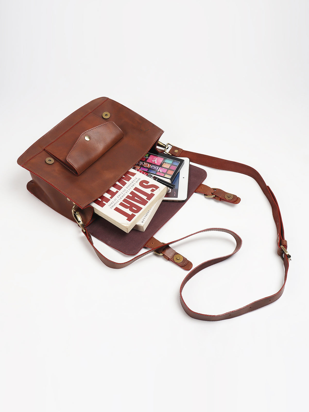 Obsidian leather sling bag flat lay — Art Avenue
