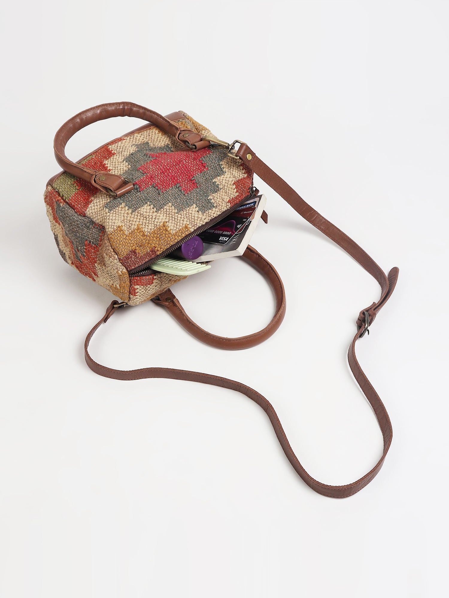 Digilent kilim and leather duffle bag flat lay — Art Avenue