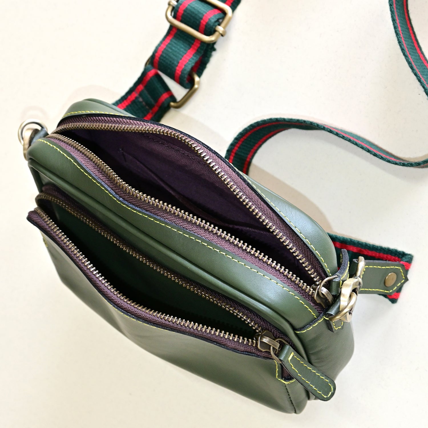 Harisson leather sling bag green interior — Art Avenue