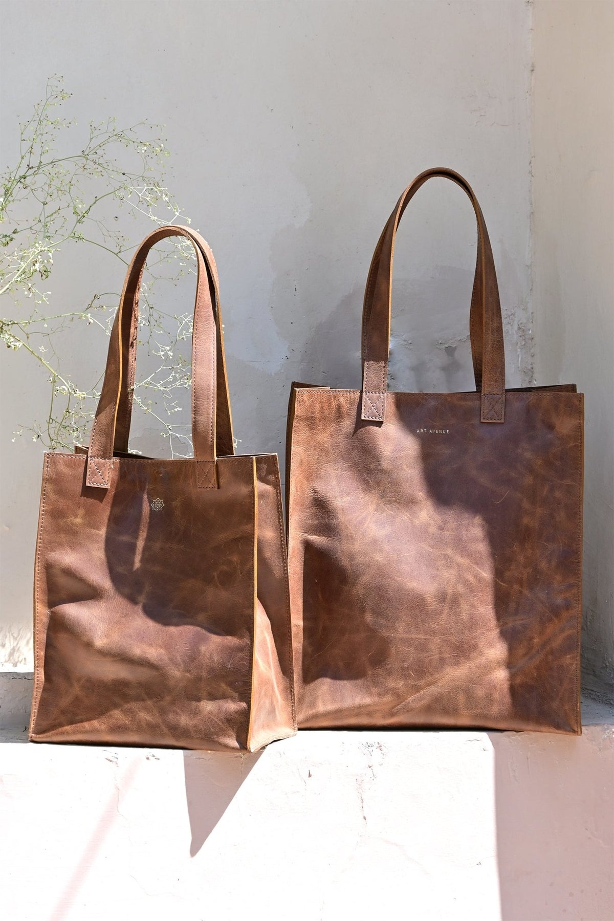 Freebie medium leather tote bag flat lay — Art Avenue