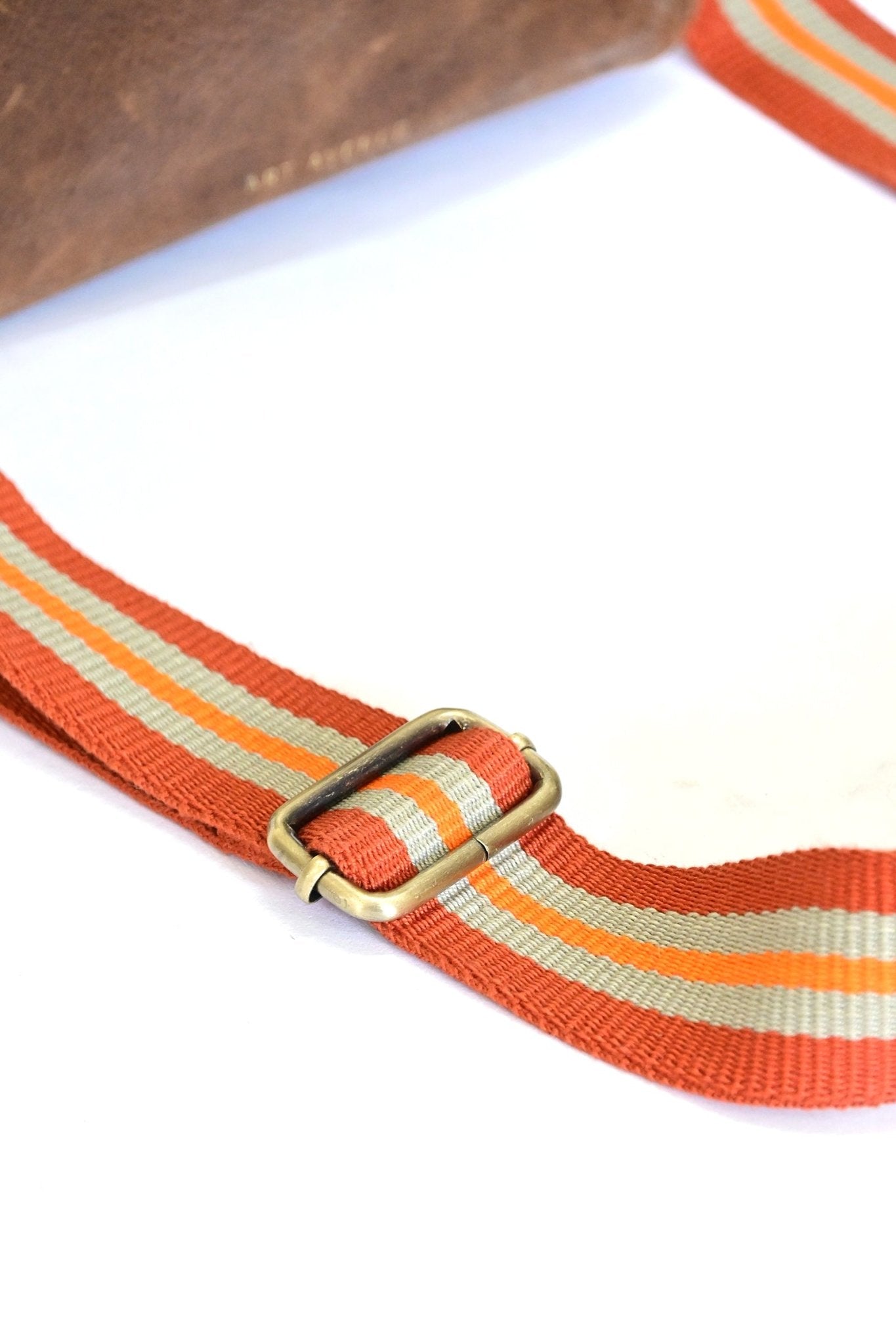 Harisson brown leather sling bag flat lay — Art Avenue