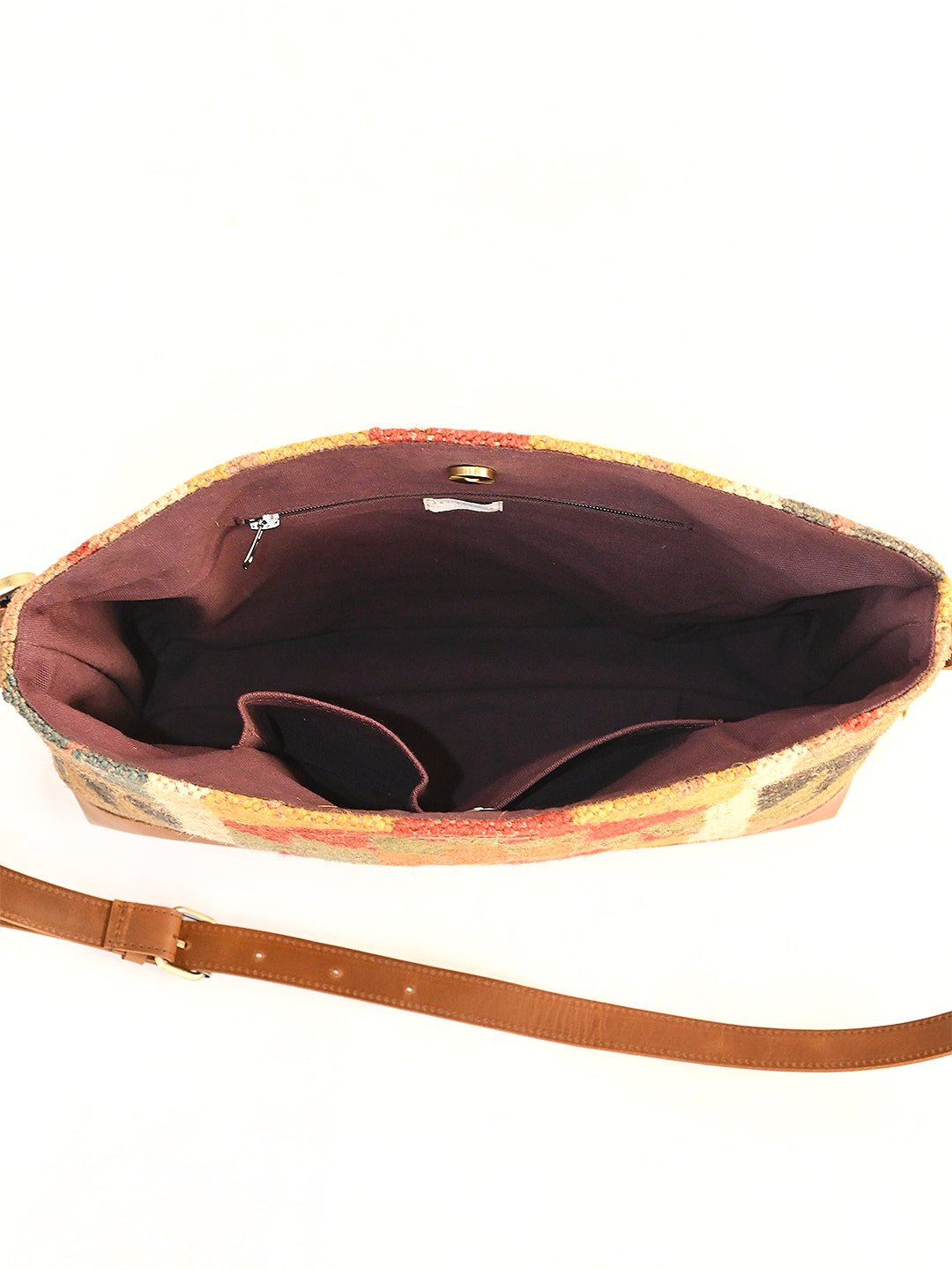 Comfrey kilim and leather handbag flat lay — Art Avenue
