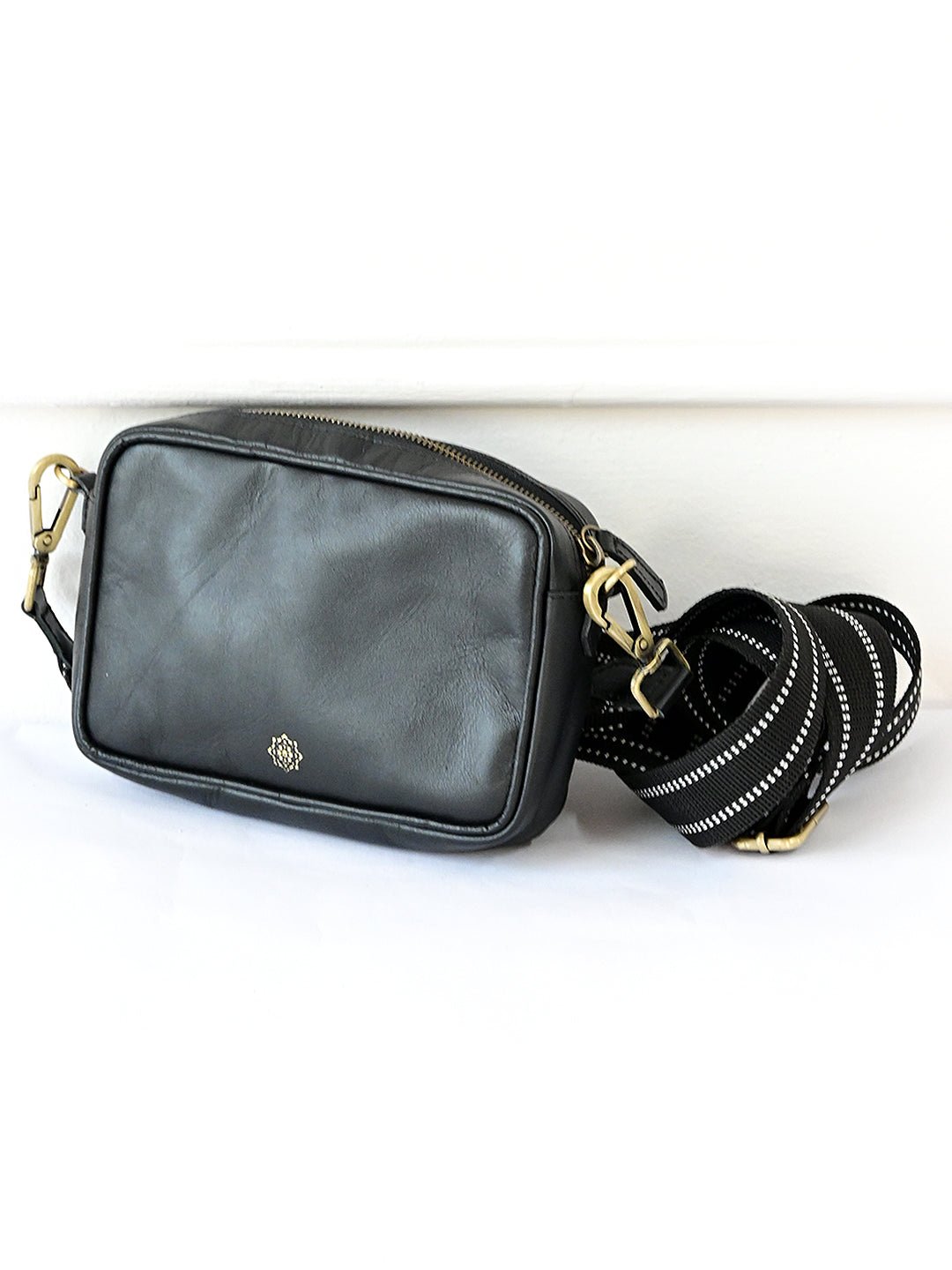 Harisson black sling bag on model — Art Avenue