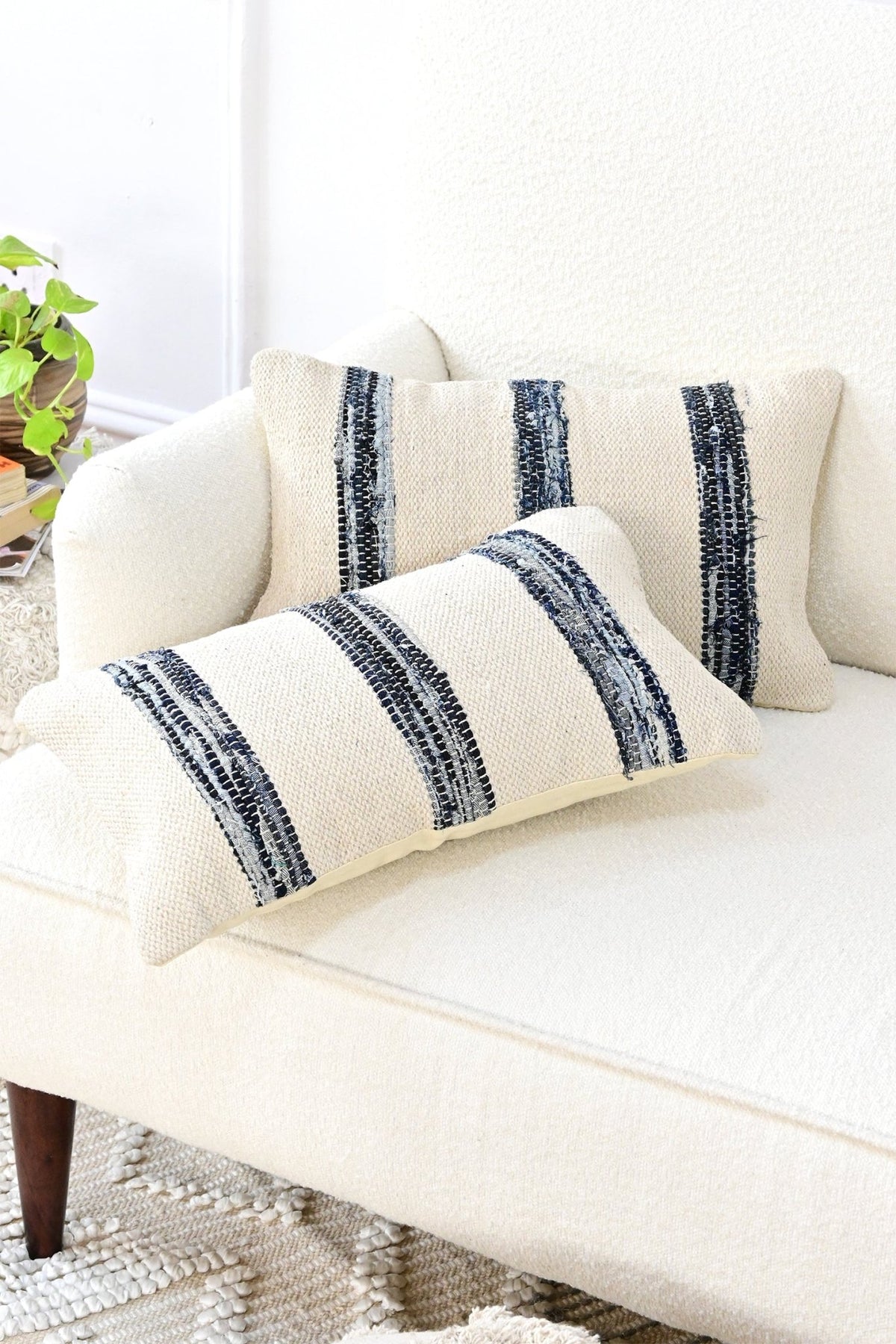 Handwoven denim chindi lumbar cushion on sofa — Art Avenue