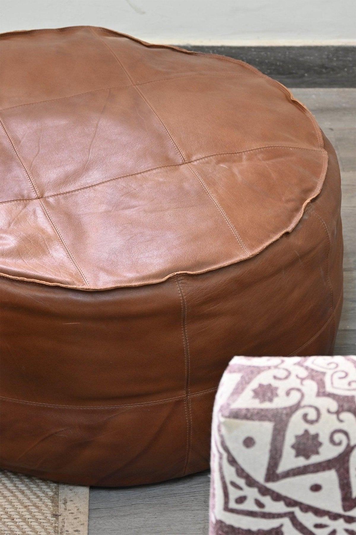 Side view of circular leather pouf — Art Avenue