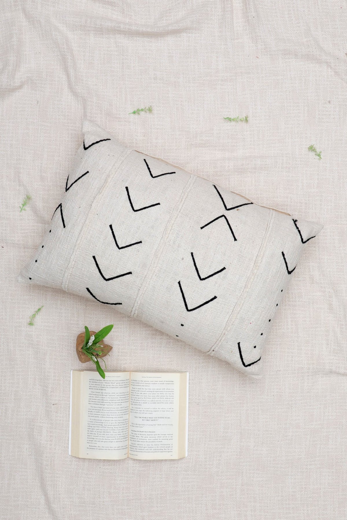 Hand-embroidered lumbar cushion on sofa — Art Avenue