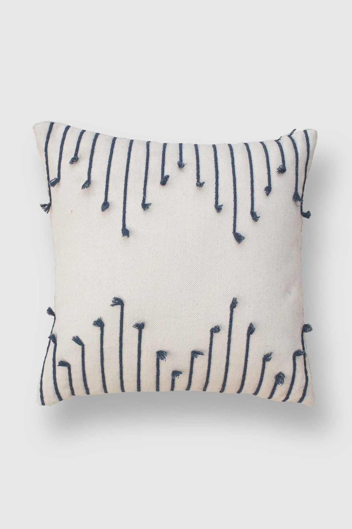 Hand-embroidered square cushion on sofa — Art Avenue